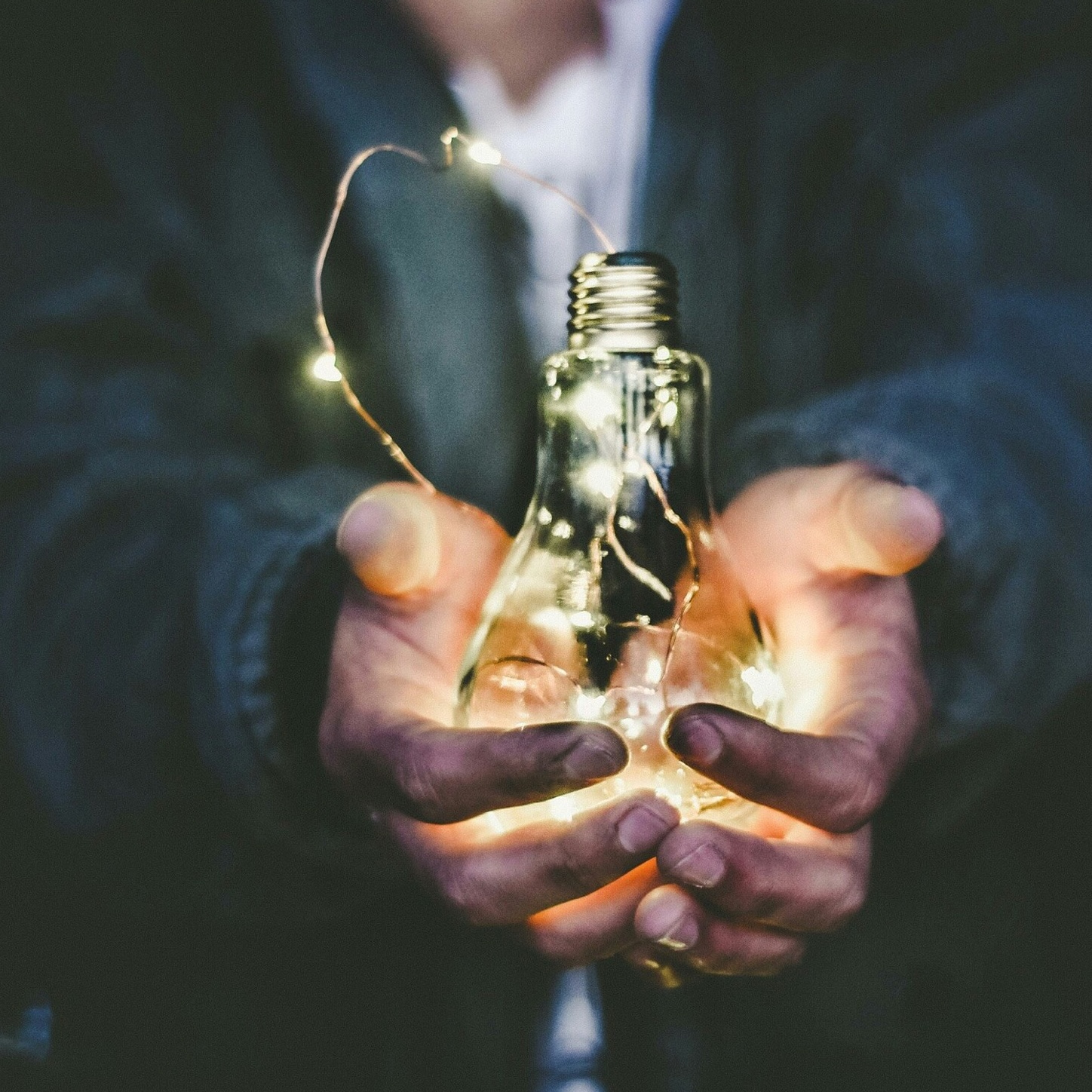 person holding lightbulb